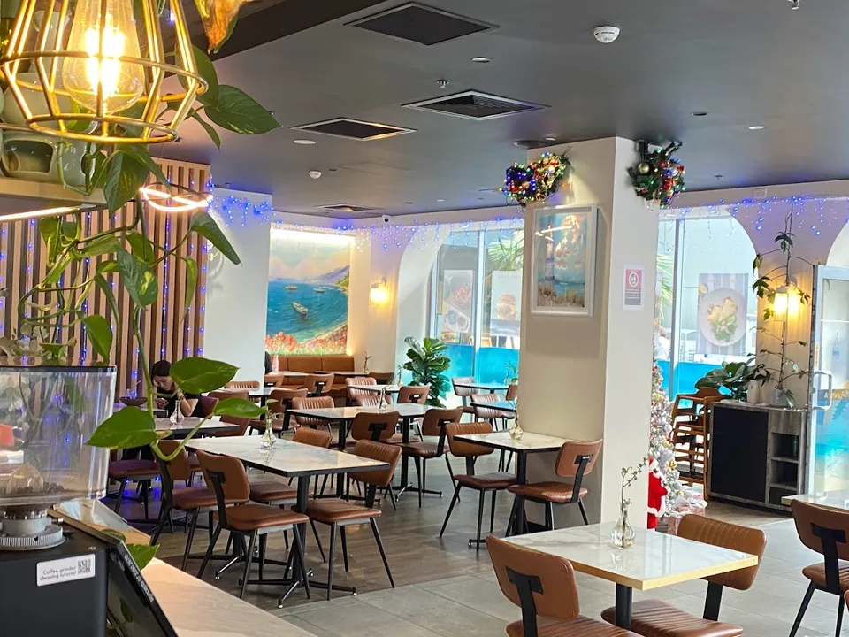 Interior of Anita's Fusion with coastal murals and warm lighting
